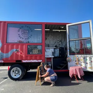 a woman setting up a food truck