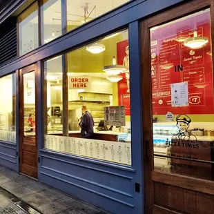 a man in the window of a restaurant