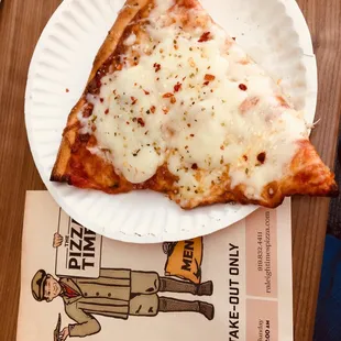 a slice of pizza on a paper plate