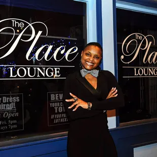 a woman standing in front of a restaurant