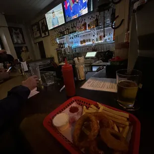 Basket of half onion rings and half fries