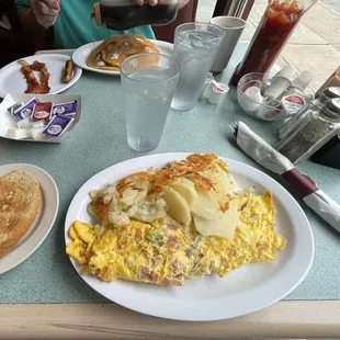 an omelet, potatoes, and toast