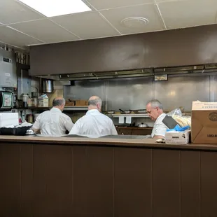 The old Greek guy's cooking up breakfast