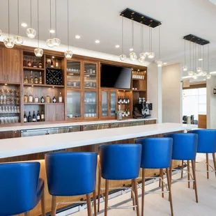 a bar with blue chairs