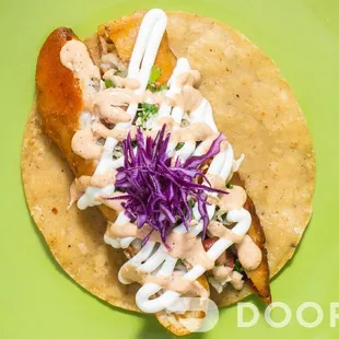 a taco on a green plate