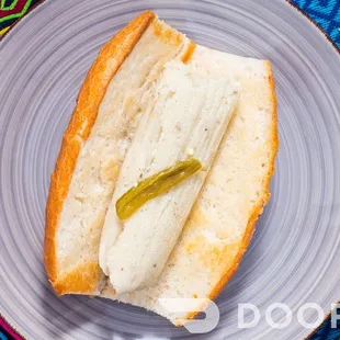 a hot dog with pickles on it