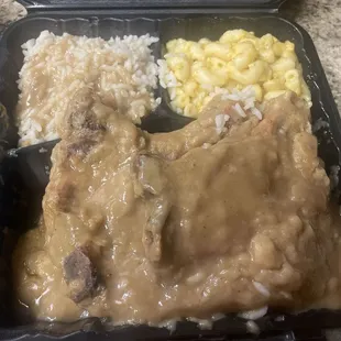Smothered pork chops with rice and Mac n cheese