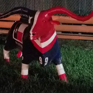 a statue of a bull wearing a jersey