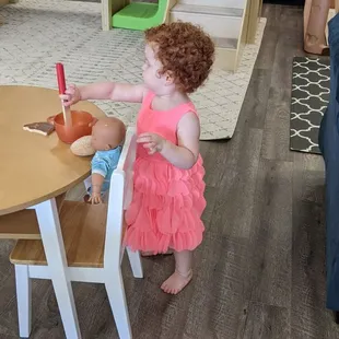 My daughter &quot;feeding&quot; a baby