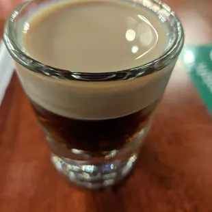 a shot of coffee in a shot glass
