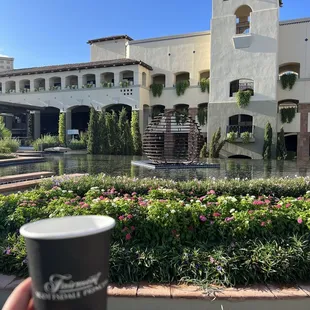 a cup of coffee in front of a building