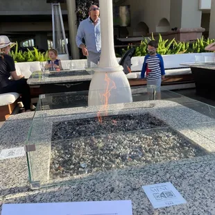 a man standing in front of a fire pit