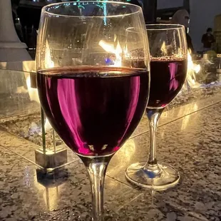 two glasses of wine on the bar