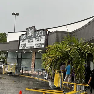 people standing in line outside of the store