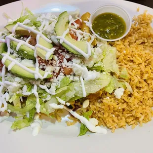 Beef &amp; chicken Taquitos underneath the salad.