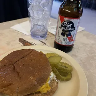 a burger and pickles on a plate
