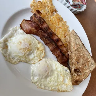 two over medium with bacon browns and toast... eggs cooked to perfection