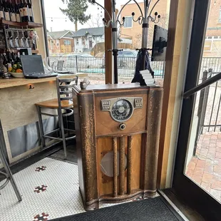 One of the absolute coolest uses of an antique I&apos;ve seen: an old Zenith heirloom stereo being repurposed as the host stand.