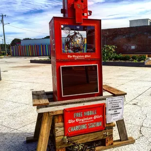 Cell phone charger in a repurposed newspaper box