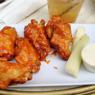 a plate of wings and carrots