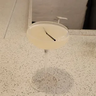 a cocktail in a glass on a counter