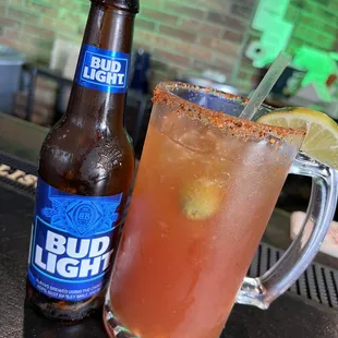 a glass of bud light and a bottle of bud light