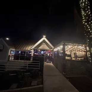 the outside of a restaurant lit up at night