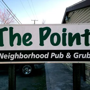 a sign for neighborhood pub and grub