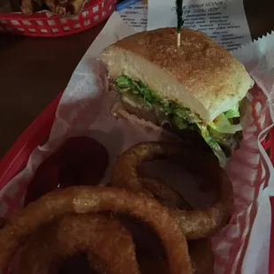 Half of a "build your own" burger and onion rings