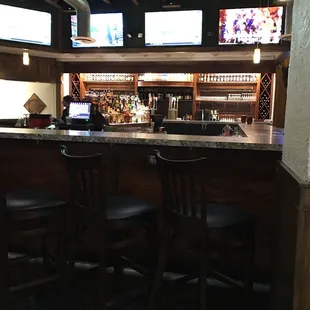 a bar with multiple televisions