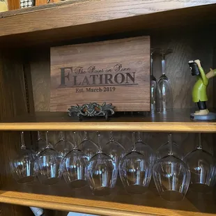 a shelf with wine glasses