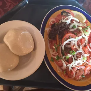Banku and Tilapia with sliced pepper/onions/tomatoes and mild African pepper.
