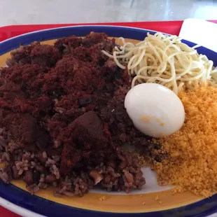 Waakye laced with egg/Gari/spaghetti and goat meat(fish and chicken as options).