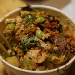 a bowl of food with chopsticks