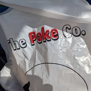 the poke co logo on a plastic bag