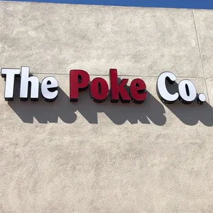 the poke co logo on the side of a building