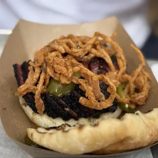 Low and slow brisket sandwich with crispy onions. Excellent barbecue.