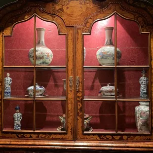 a display case with vases in it