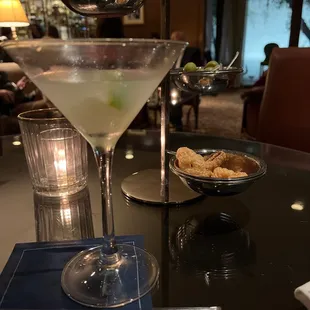 a martini and a bowl of chips