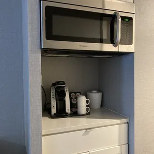 A microwave and coffee maker were in the room