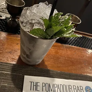 a drink with ice and mint