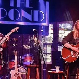 a man and a woman playing guitars