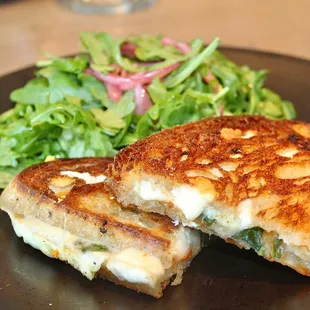 The Cheesy Grilled Cheese was made with fontina val d'aosta, goat cheese, pecorino, tomato jam, rebel bakery sourdough, arugula salad