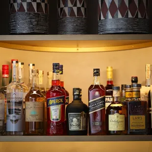 a shelf full of liquor bottles
