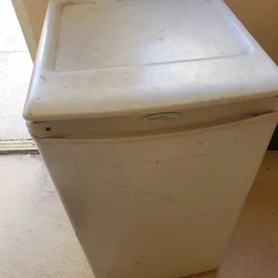 really disgusting refrigerator with broken door.