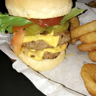 Double cheeseburgwr with fried onions, pickle, ketchup, lettuce and tomotao