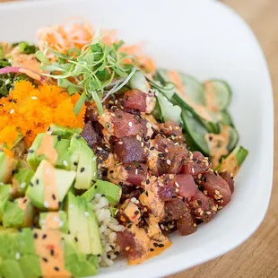 Big Eye Tuna Poke with brown rice or salad, cucumbers, avocado, seaweed, spicy aioli