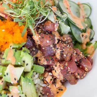 Big Eye Tuna Poke with brown rice or salad, cucumbers, avocado, seaweed, spicy aioli