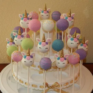 a cake with unicorns and unicorn heads
