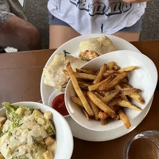 a plate of french fries and a bowl of salad